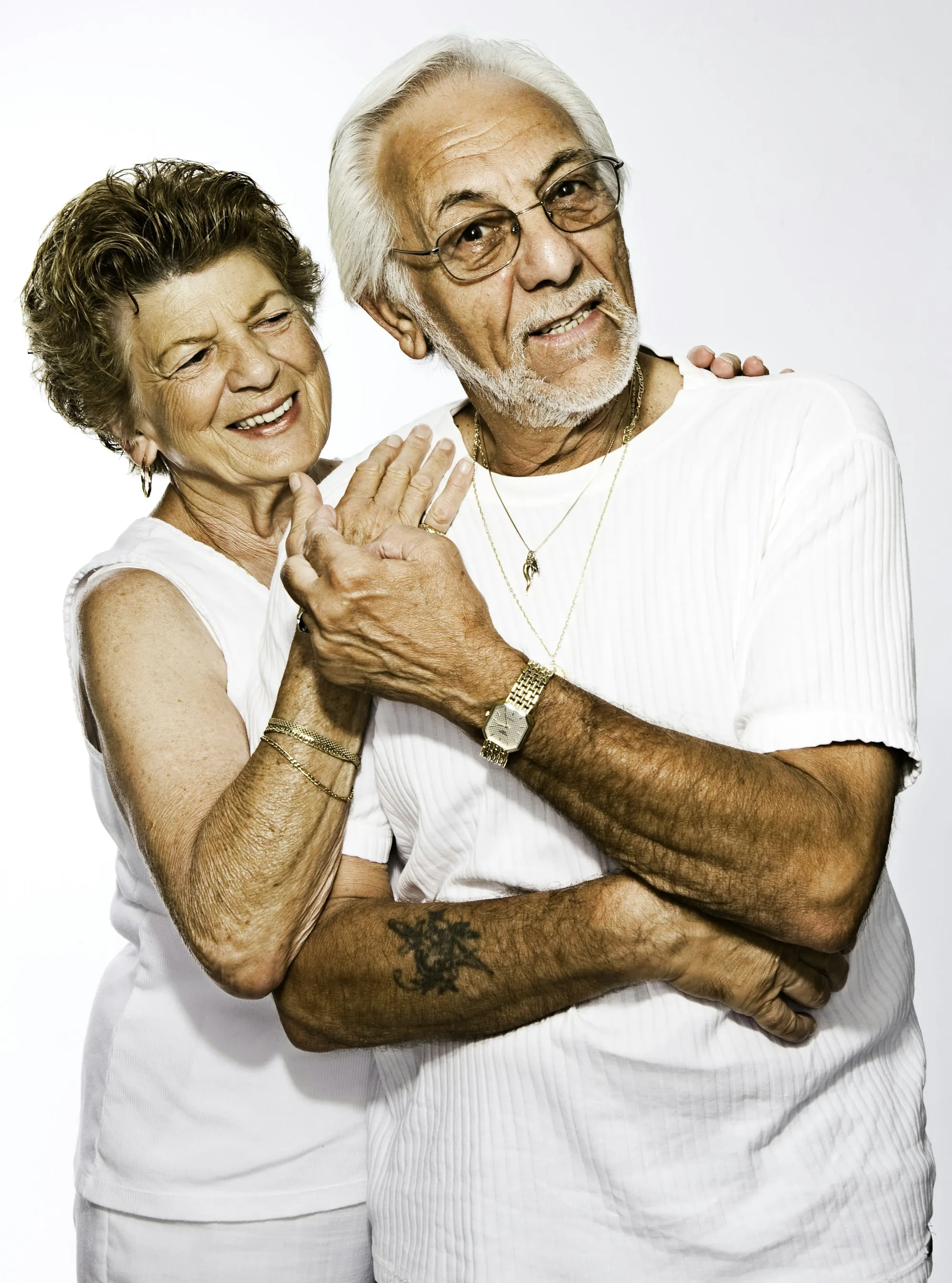 Older couple holding hands and laughing
