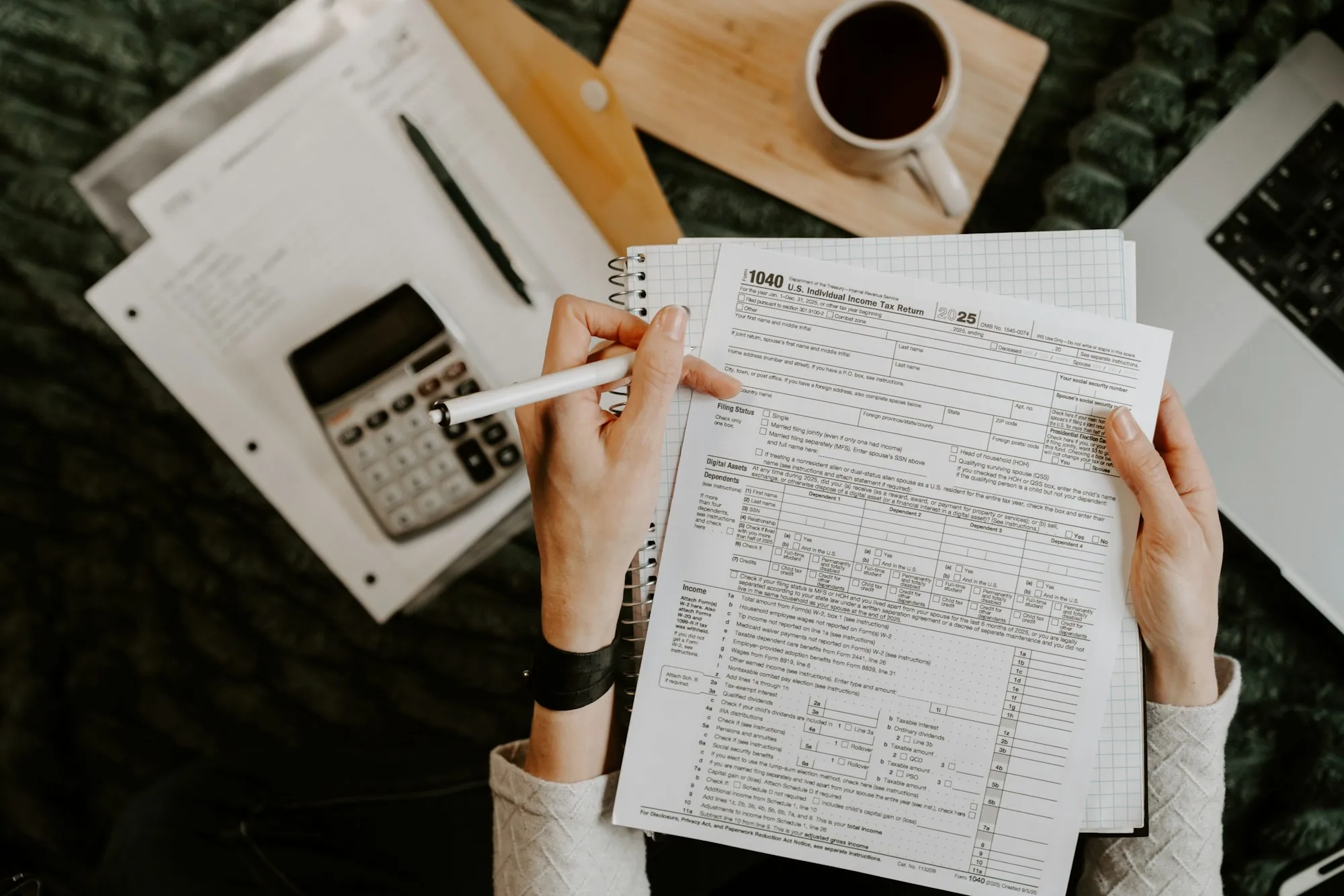 Person filling out forms at a desk